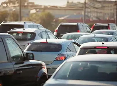 A congested traffic scene with numerous cars stuck in a jam, causing a significant delay in movement.